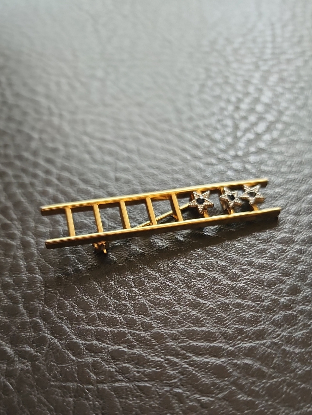 Gold-Tone Ladder Bar Brooch with Star Accents